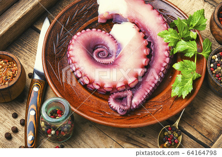 Raw octopus on wooden table Raw octopus on wooden table 64164798