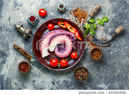 Raw octopus on plate Raw octopus on plate 64164806