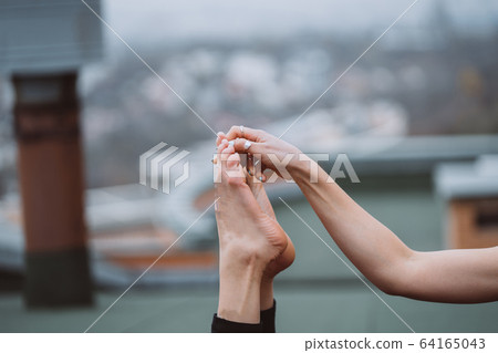 Woman practicing yoga on the roof and doing yoga exercises Woman practicing yoga on the roof and doing yoga exercises 64165043