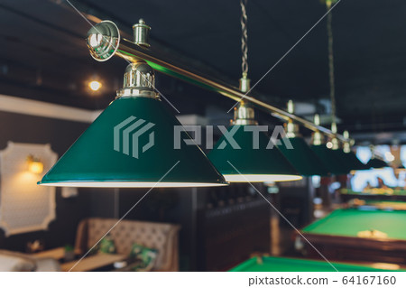 lamp over billiards green table balls and cues. lamp over billiards green table balls and cues. 64167160