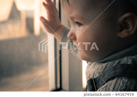 Cutie little baby girl looking out the window Cutie little baby girl looking out the window 64167459