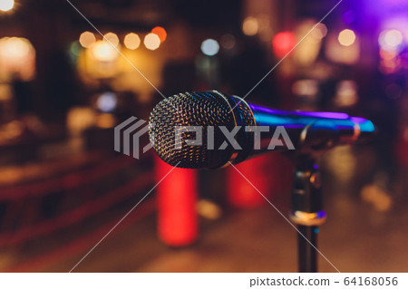 Close up of microphone in concert hall or conference room. 64168056