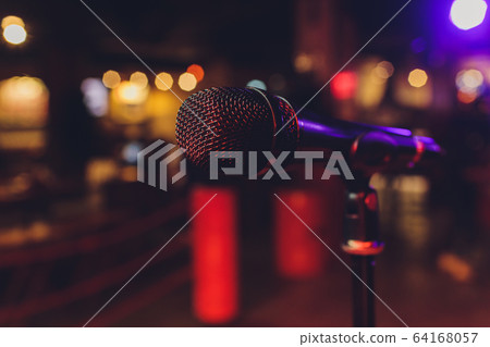 Close up of microphone in concert hall or conference room. 64168057