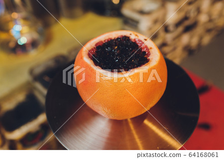 Hookah on orange with mint and citrus fruit. Hookah on orange with mint and citrus fruit. 64168061