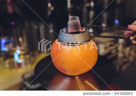 Hookah on orange with mint and citrus fruit. Hookah on orange with mint and citrus fruit. 64168063