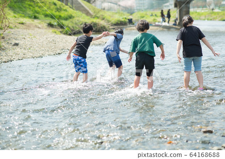 Elementary school students playing in the river Elementary school students playing in the river 64168688
