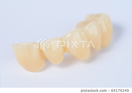 Close up ceramic tooth crown Close up ceramic tooth crown 64170249