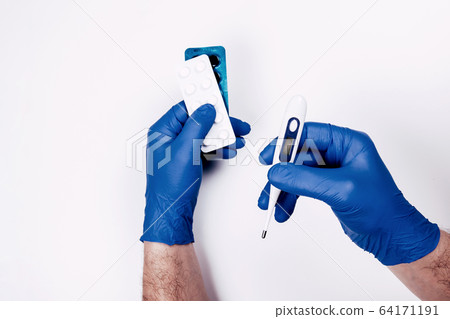 Man handshold thermometer and medicine pills Man handshold thermometer and medicine pills 64171191