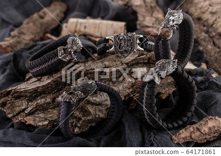 Moscow, Russia - 08/21/2019: Decoration, bracelet for men and women from the paracord on the braided bracelet made of cord Moscow, Russia - 08/21/2019: Decoration, bracelet for men and women from the paracord on the braided bracelet made of cord 64171861