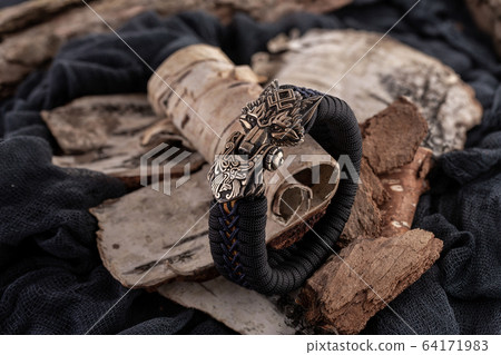 Moscow, Russia - 08/21/2019: Decoration, bracelet for men and women from the paracord on the braided bracelet made of cord Moscow, Russia - 08/21/2019: Decoration, bracelet for men and women from the paracord on the braided bracelet made of cord 64171983