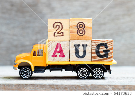 Truck hold letter block in word 28aug on wood background Truck hold letter block in word 28aug on wood background 64173633