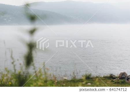 Morning fog green plans on Lake Baikal Siberia Russia 64174712