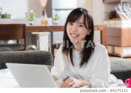 Young woman playing computer at home Young woman playing computer at home 64175131