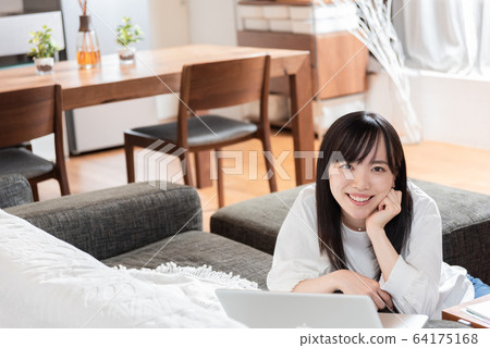 A young woman relaxing at home A young woman relaxing at home 64175168