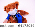 Teedy bear in face mask with doctor hands 64178039