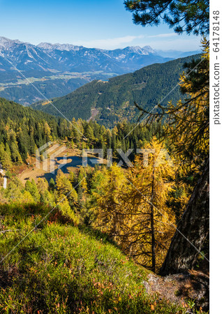Calm autumn Alps mountain lake with clear Calm autumn Alps mountain lake with clear 64178148