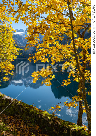 Peaceful autumn Alps mountain lake with clear Peaceful autumn Alps mountain lake with clear 64178160