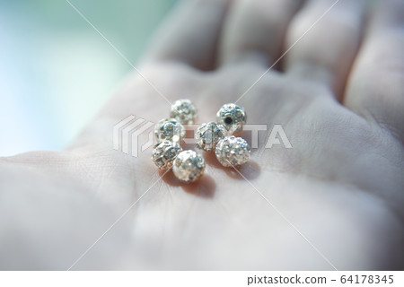 silver beads with crystals on the hand 64178345