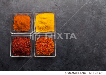 Various spices in bowls 64178373