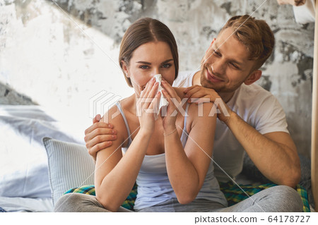 Delighted couple spending their weekend at home 64178727