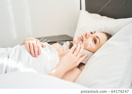 Pleased pretty female calling on the cellphone Pleased pretty female calling on the cellphone 64179247