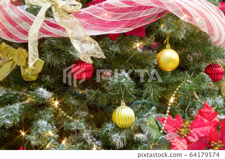 christmas tree garland and bauble decorations with lights and poinsettia christmas tree garland and bauble decorations with lights and poinsettia 64179574
