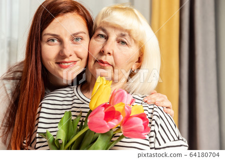 Mother and young daughter are hugging. Happy loving family. Happy mother's day. 64180704