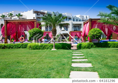 swimming pool with coconut tree and white umbrella swimming pool with coconut tree and white umbrella 64181296