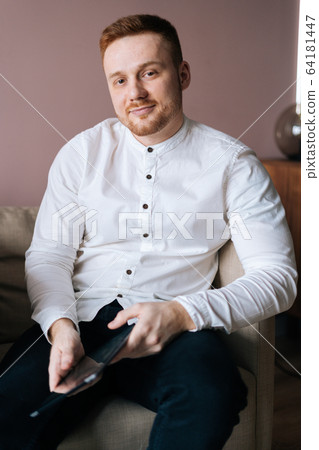 Portrait of bearded young man posing with digital tablet in hands, 64181447