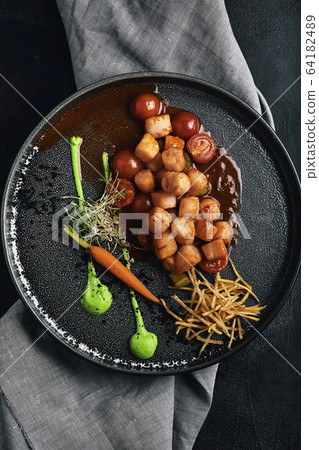 Grilled scallops with vegetables and sauce, a beautiful presentation from the chef, food photo, dark background. copy space, seafood food concept. Close-up, top view 64182489