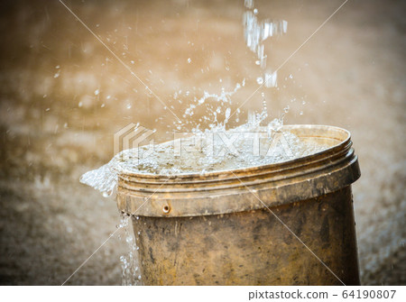 rainwater harvesting in the bucket after heavy 64190807