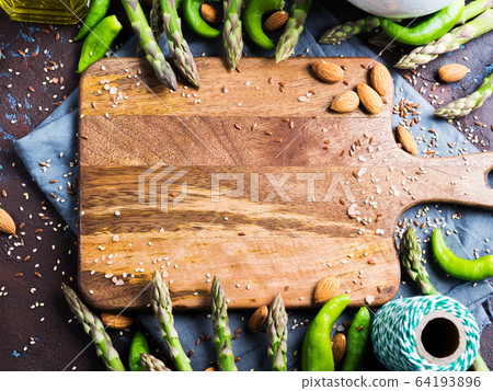Wooden chopping board with asparagus, nuts, salt Wooden chopping board with asparagus, nuts, salt 64193896