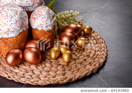 Easter eggs gold and bronze and Easter cake 64193960
