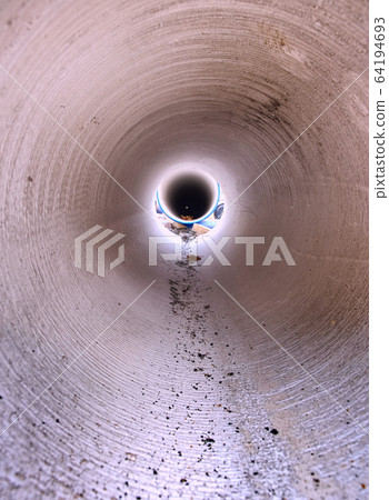 Looking inside of the large diameter HDPE pipe Looking inside of the large diameter HDPE pipe 64194693