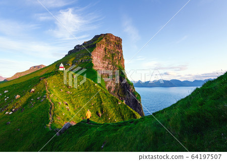 Kallur lighthouse on green hills of Kalsoy island Kallur lighthouse on green hills of Kalsoy island 64197507