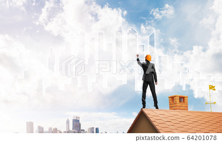 Man architect draw silhouette of modern city on blue sky. Mixed media Man architect draw silhouette of modern city on blue sky. Mixed media 64201078