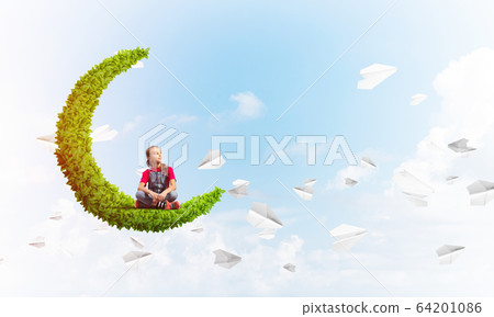 Concept of careless happy childhood with girl on green moon 64201086