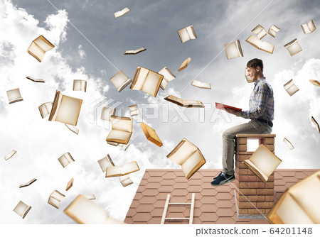Man reading book and many of them flying in air Man reading book and many of them flying in air 64201148