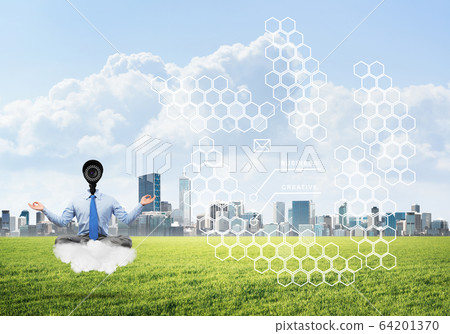 Camera headed man sitting in lotus pose on cloud against modern cityscape 64201370