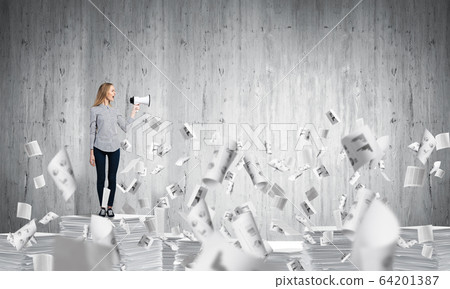 Woman keeping megaphone in hand. 64201387