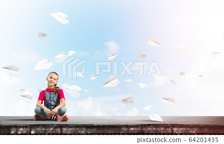Concept of careless happy childhood with girl of school age smilling 64201435
