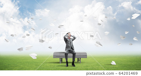Young man in suit in park dont want to hear anything 64201469