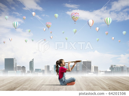 Concept of careless happy childhood with girl looking in spyglass Concept of careless happy childhood with girl looking in spyglass 64201506