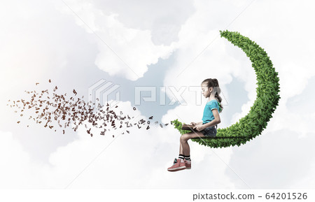 Concept of careless happy childhood with girl on green moon Concept of careless happy childhood with girl on green moon 64201526
