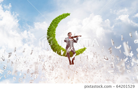 Handsome businessman play his melody and symbols fly around in air 64201529