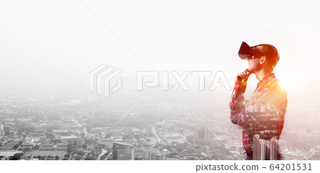 Guy wearing checked shirt and virtual mask holding hand on chin 64201531