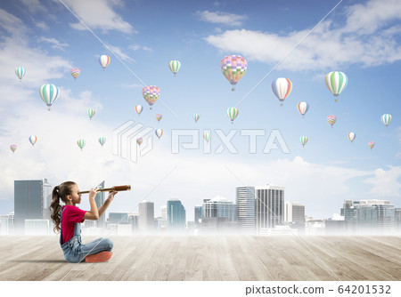 Concept of careless happy childhood with girl looking in spyglass 64201532