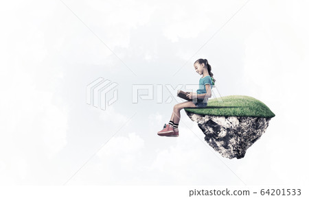 Concept of careless happy childhood with girl reading book 64201533