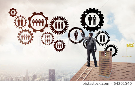 Businessman on house roof presenting teamwork and connection con Businessman on house roof presenting teamwork and connection con 64201540