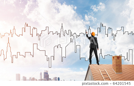 Man architect draw silhouette of modern city on blue sky. Mixed media 64201545